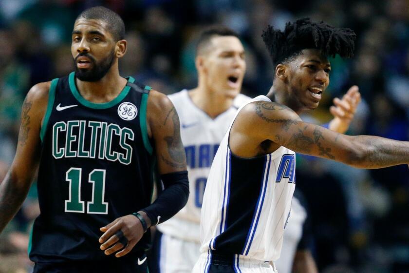 Orlando Magic's Elfrid Payton, right, and Aaron Gordon, behind, protest a call beside Boston Celtics' Kyrie Irving (11) during the first quarter of an NBA basketball game in Boston, Sunday, Jan. 21, 2018. The Magic won 103-95. (AP Photo/Michael Dwyer)