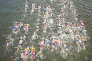 Athletes compete in the swim leg of the women's individual triathlon competition.