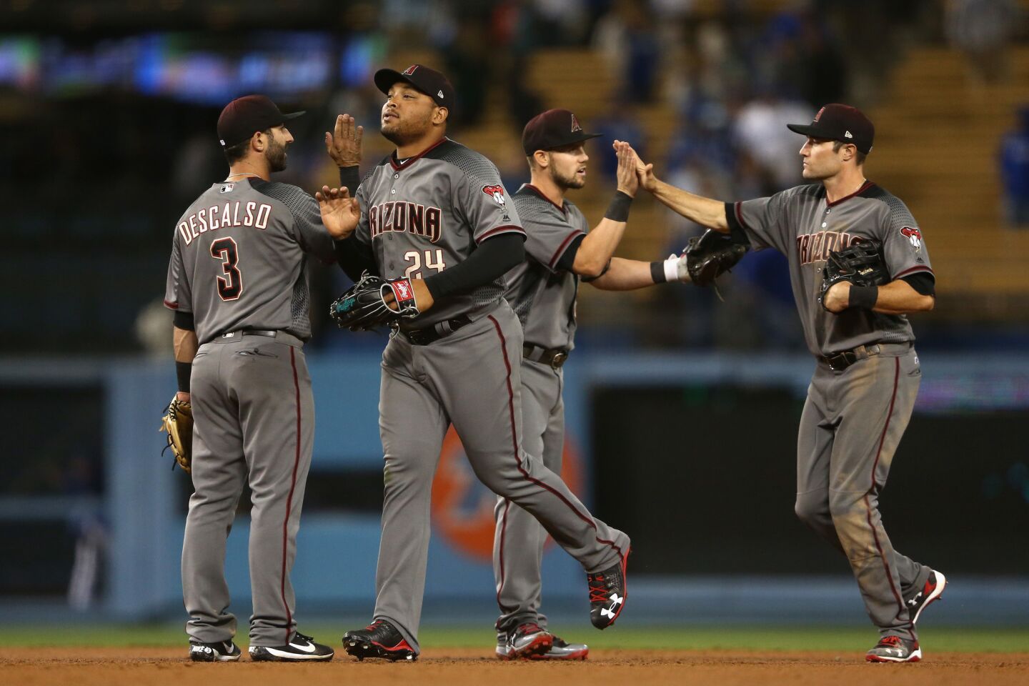 LOS ANGELES, CA - APRIL 17: Yasmany Tomas #24 ,Daniel Descalso #3, A.J. Pollock #11, and Chris Owings #16 of the Arizona Diamondbacks celebrate defeating the Los Angeles Dodgers 4-2 in a game at Dodger Stadium on April 17, 2017 in Los Angeles, California. (Photo by Sean M. Haffey/Getty Images) ** OUTS - ELSENT, FPG, CM - OUTS * NM, PH, VA if sourced by CT, LA or MoD **
