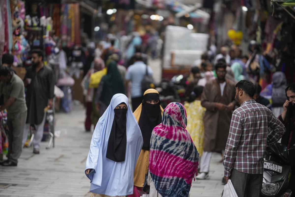 People walk at a busy market.