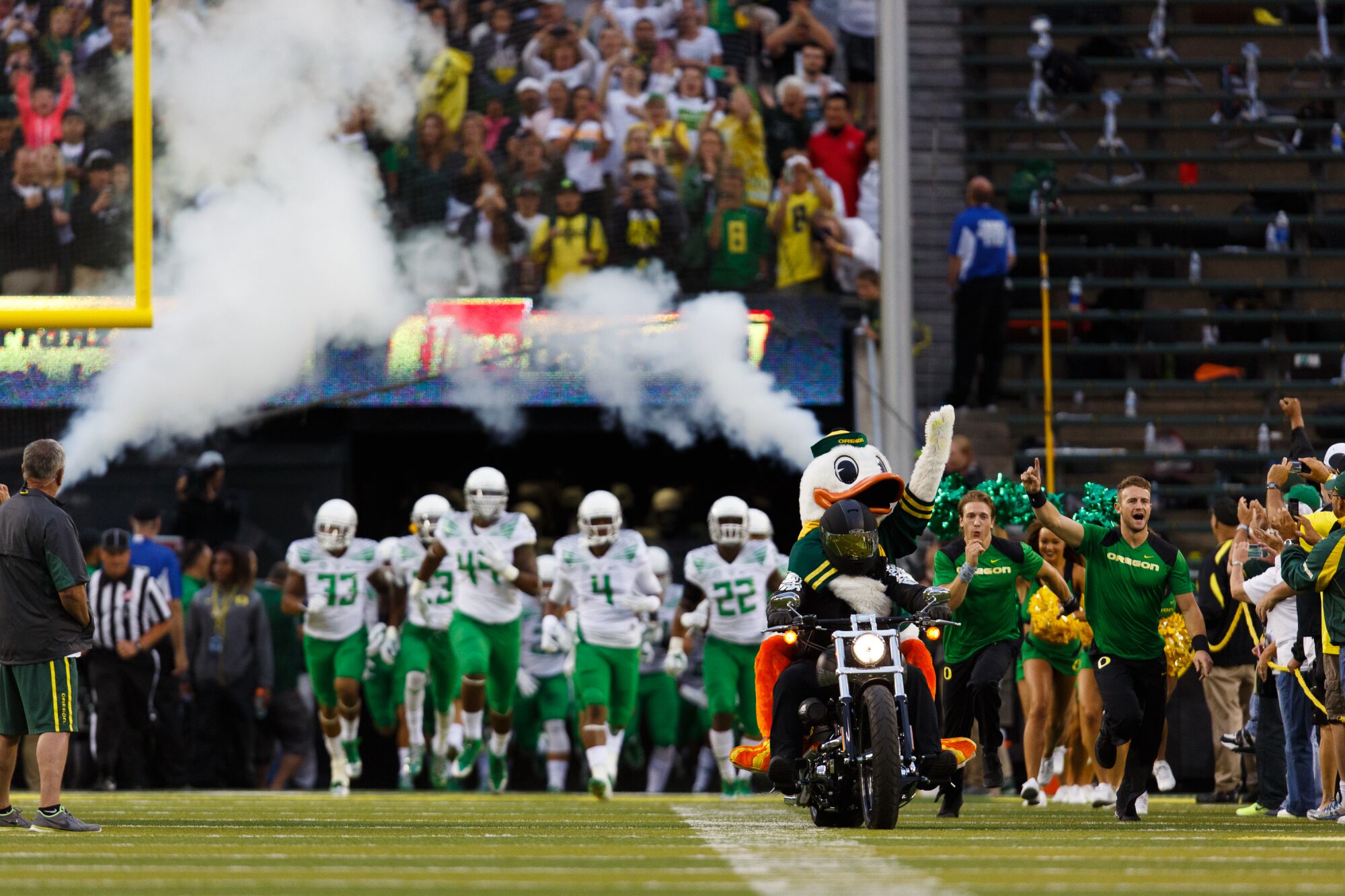 The University of Oregon football team runs out of the tunnel.