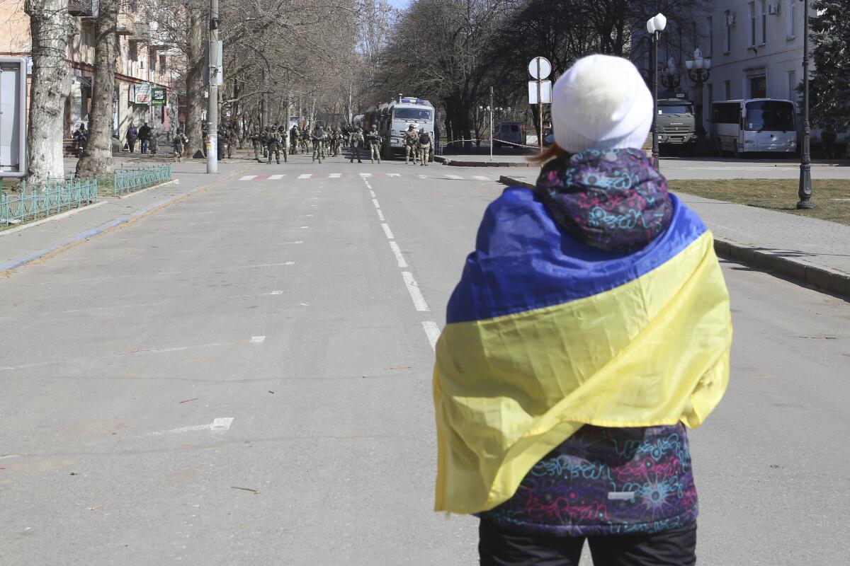 Protester wrapped in Ukrainian flag in Kherson, southern Ukraine