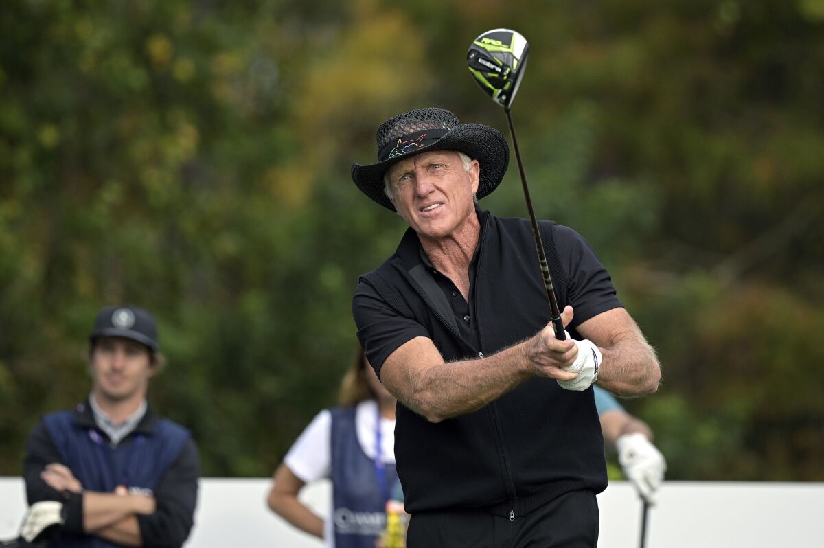FILE - Greg Norman, of Australia, watches his tee shot on the first hole during the final round of the PNC Championship golf tournament on Dec. 20, 2020, in Orlando, Fla. Norman is heading up a Saudi-backed company that plans 10 new tournaments on the Asian Tour to attract top players. It could be the first step toward Norman trying again to start a world tour. (AP Photo/Phelan M. Ebenhack, File)