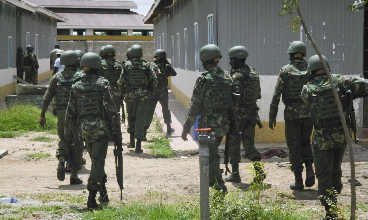 Soldiers from the Kenya Defence Forces patrol Monday inside the Garissa University College compound that was the scene of last week's attack by Shabab gunmen, in Garissa, Kenya.