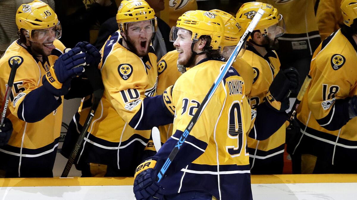 Predators center Ryan Johansen celebrates with teammates on the bench after scoring against the Blues early in the third period Sunday.