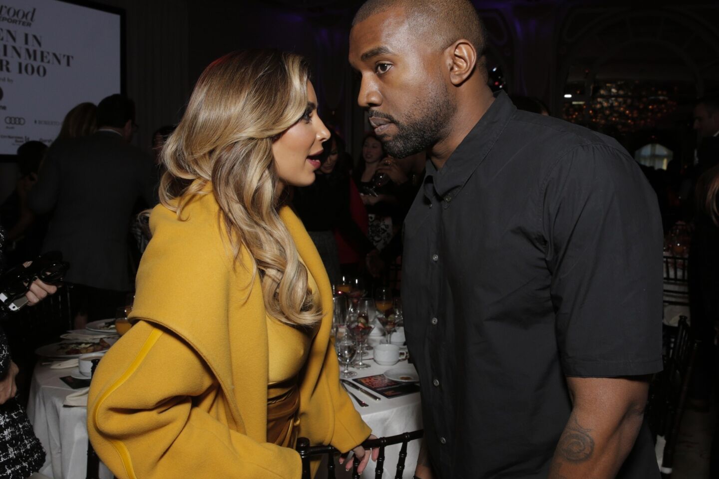 Kim Kardashian, left, and Kanye West attend the Hollywood Reporter's celebration of power 100 women in entertainment breakfast on Dec. 11, 2013, in Beverly Hills.