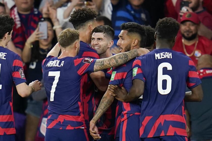 United States players celebrate with Christian Pulisic, center, after he scored a goal.