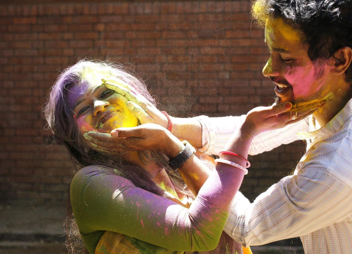 Bangladeshi students smear each other with colored powder during the Holi Festival in Dhaka, Bangladesh, 08 March 2015. Holi, which literally means 'burning', is celebrated on the full moon day in the month of Phalguna and heralds the onset of spring season.