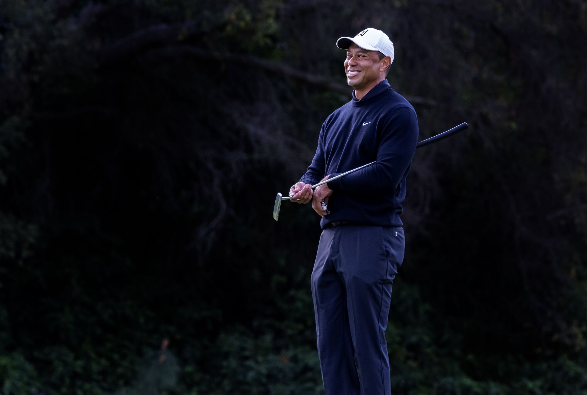 Tiger Woods smiles at Rory McIlroy after McIlroy made a 65 foot chip-in for birdie 