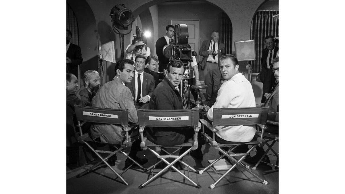 March 28, 1966: On the set of the Paramount movie "Warning Shot" are the holdout pitchers flanked by the star of the film.