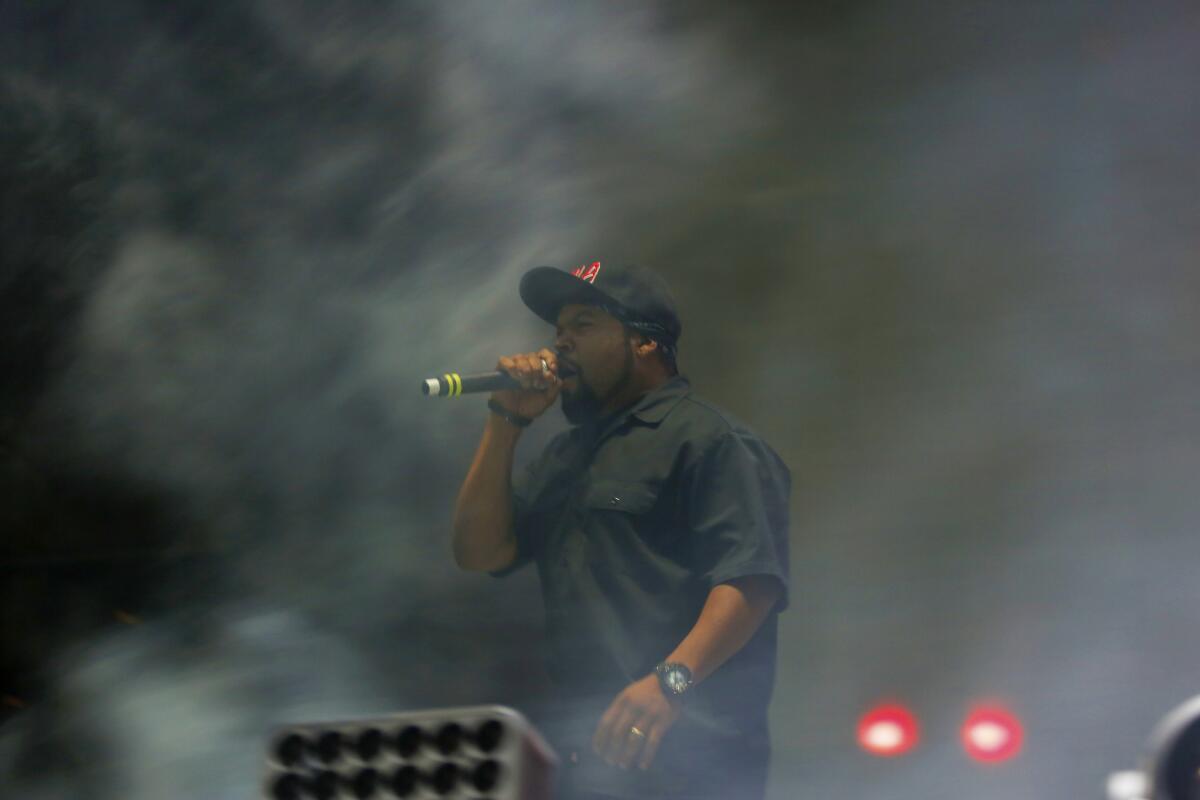 Ice Cube performs among the smoke-filled stage during the Hard Summer dance music festival.