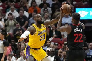 Los Angeles Lakers forward LeBron James (23) defends Miami Heat forward Jimmy Butler (22) during the first half of an NBA basketball game, Monday, Nov. 6, 2023, in Miami. (AP Photo/Lynne Sladky)