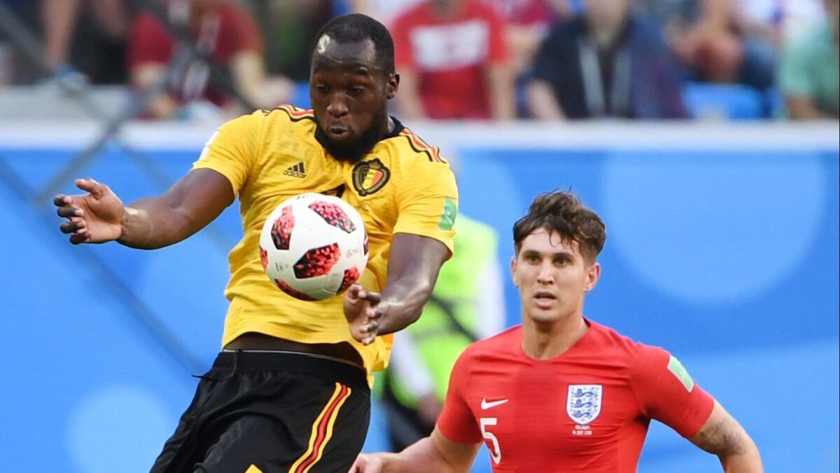 Belgium's forward Romelu Lukaku, left, jumps to control the ball in front of England's defender John Stones during their World Cup playoff for third place between Belgium and England on July 14.