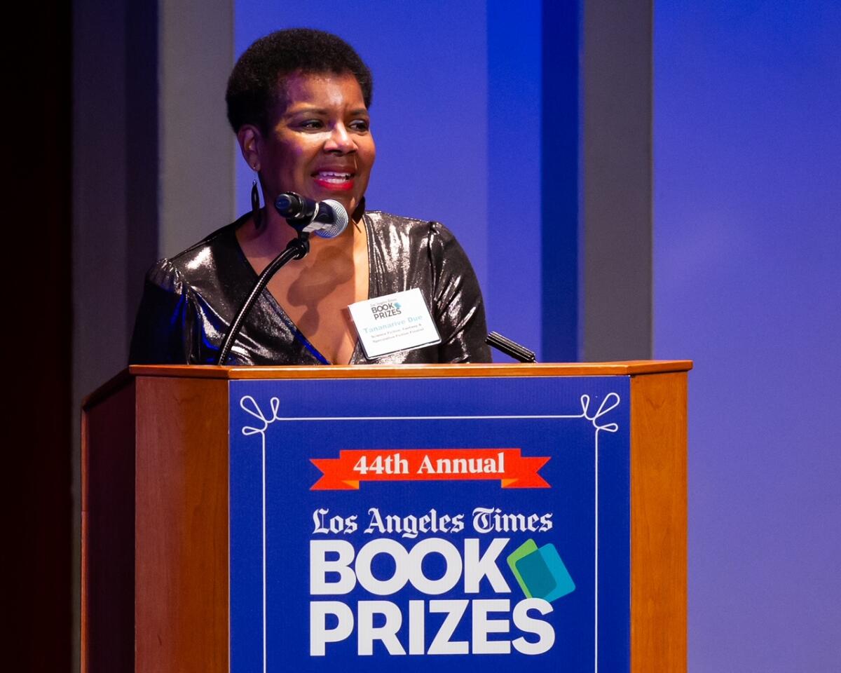 A woman with close cropped hair and a shimmering dress speaks from the lectern at the L.A. Times Book Prizes.