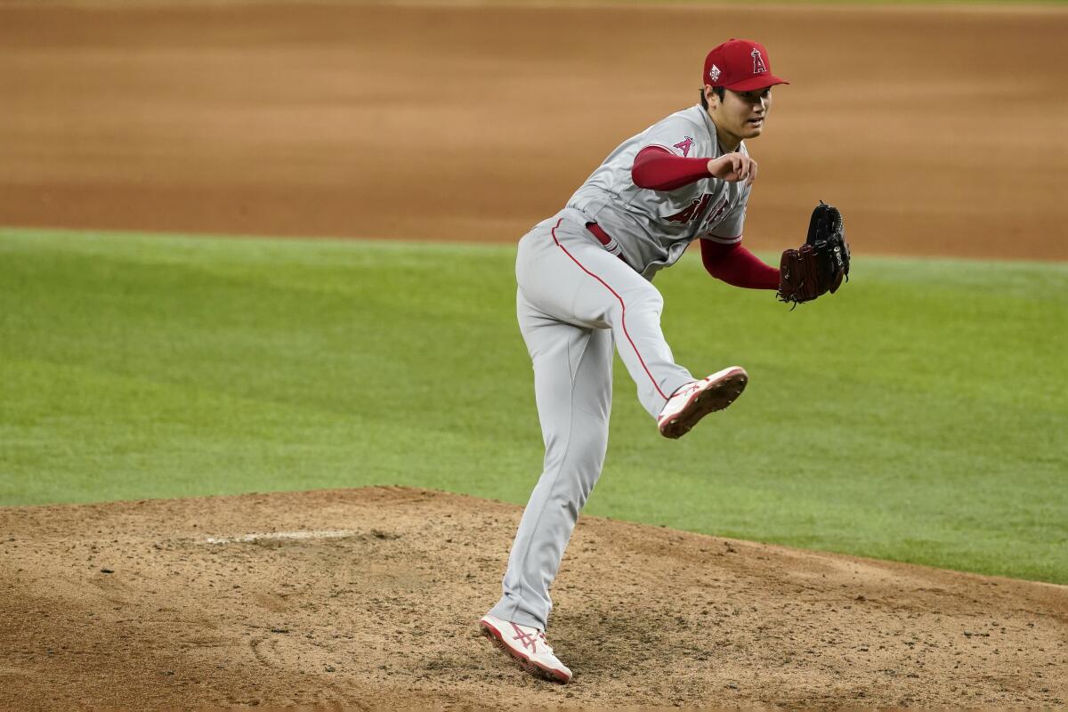 Los Angeles Angels starting pitcher Shohei Ohtani follows through on his delivery to the Texas Rangers in the sixth inning of a baseball game in Arlington, Texas, Wednesday, Aug. 4, 2021. (AP Photo/Tony Gutierrez)