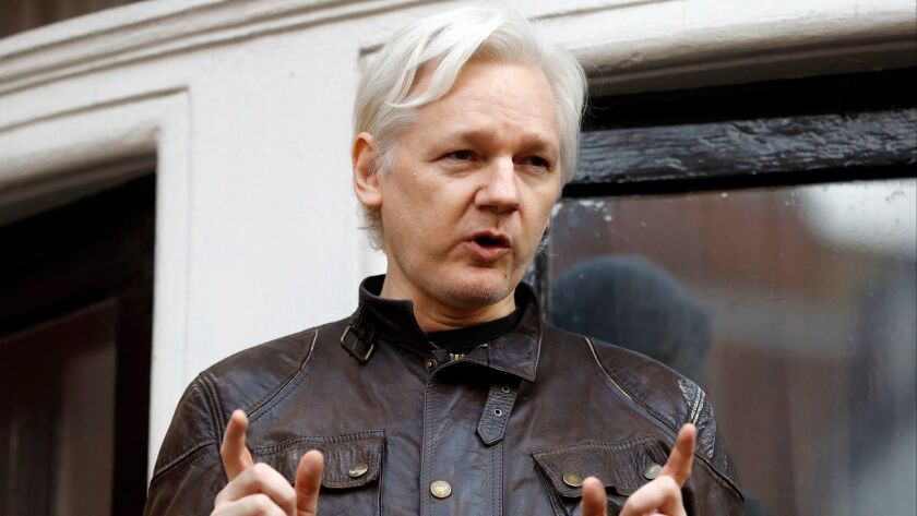 In this May 19, 2017, file photo, WikiLeaks founder Julian Assange gestures to supporters outside the Ecuadorean embassy in London, where he has been in self-imposed exile since 2012.