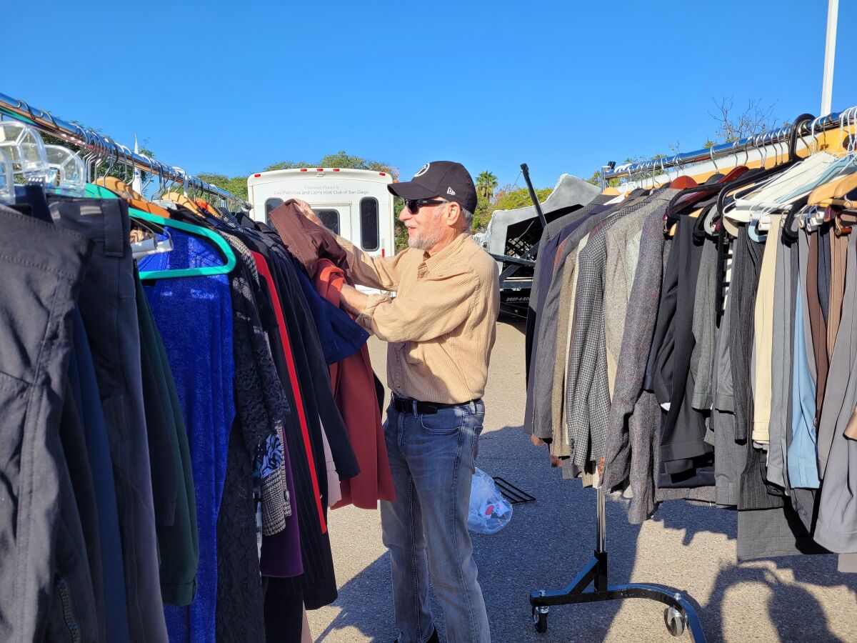 Rotary Club of La Jolla President David Shaw sorts clothes at a recent club project for the Armed Services YMCA.