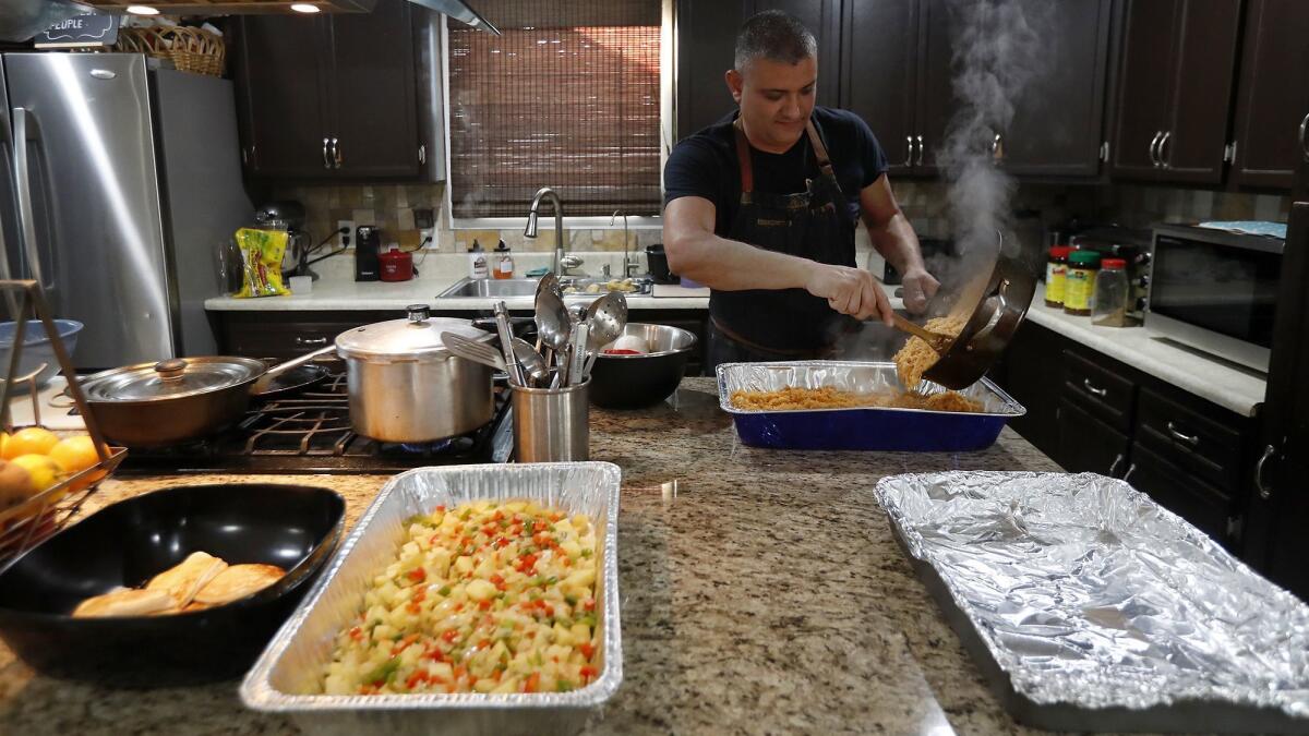 Steve Rivera, 43, a Transportation Security Administration agent, makes Spanish rice at his Garden Grove home as he cooks breakfast to share with fellow TSA workers at John Wayne Airport.
