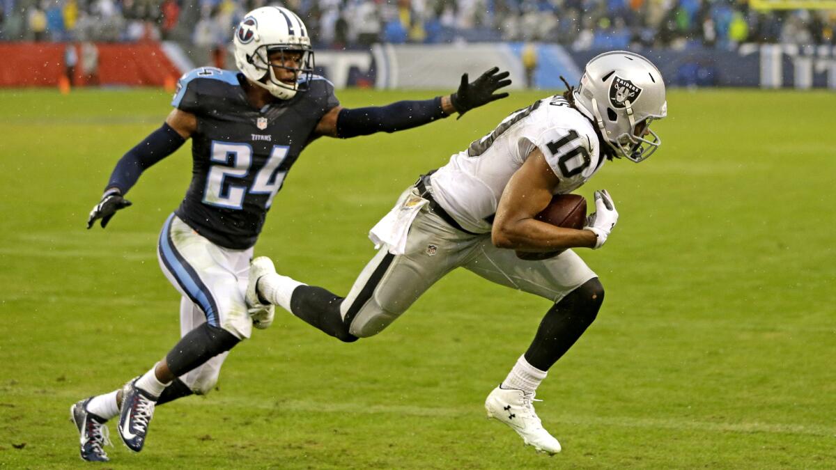 Raiders wide receiver Seth Roberts (10) catches a 12-yard touchdown pass against Titans cornerback Coty Sensabaugh in the fourth quarter Sunday.