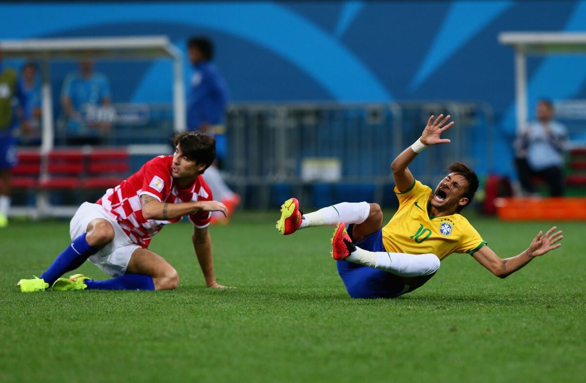 Brazil's Neymar falls after a foul by Croatia's Dejan Lovren during a Group A match on June 12.