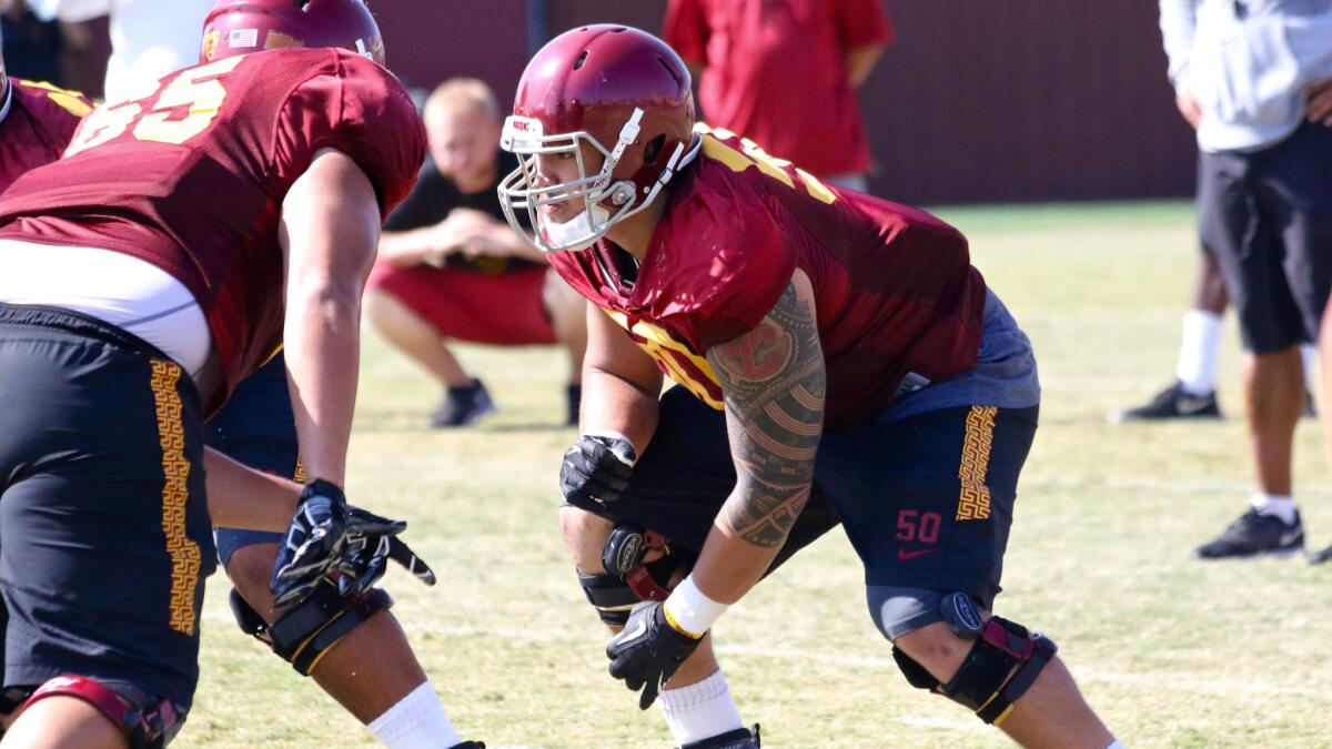 USC offensive lineman Toa Lobendahn goes through a blocking drill during a fall practice.