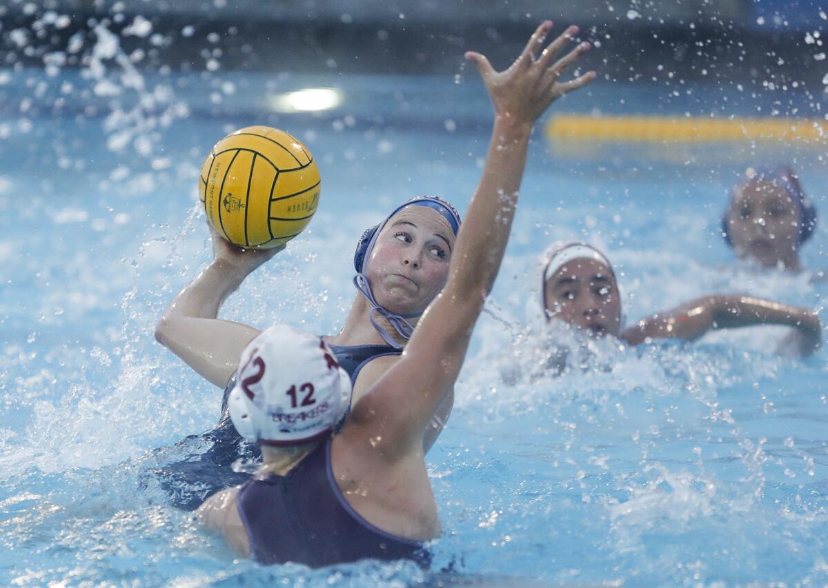 Newport Harbor's Taylor Smith pulls back from Laguna Beach defender Ava Knepper and scores a goal in Thursday's match.