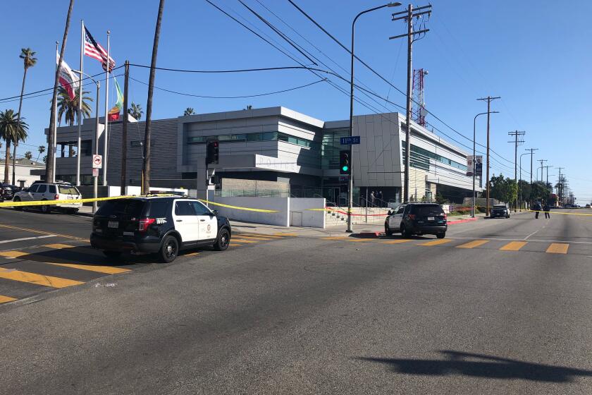 Police tape surrounds the LAPD's Olympic station after a police shooting outside.