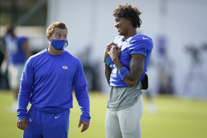 Los Angeles Rams head coach Sean McVay, left, talks to wide receiver Josh Reynolds during an NFL football camp practice Wednesday, Aug. 19, 2020, in Thousand Oaks, Calif. (AP Photo/Marcio Jose Sanchez)