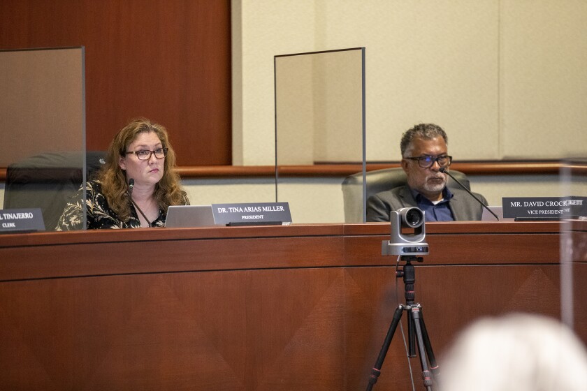 President Tina Arias Miller and Vice President David Crockett listen to a speaker during public comments.