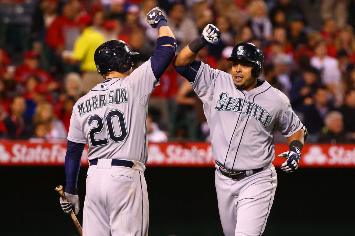 Mariners teammates Logan Morrison and Nelson Cruz celebrate Cruz's major-league leading 14th home run with a forearm bump. Morrison also homered in Seattle's 3-2 win.