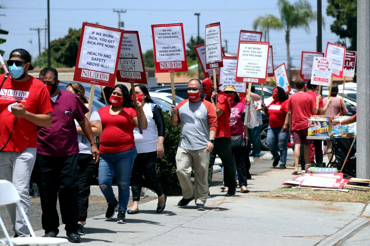 Kindred Hospital employees protest outside the main entrance.