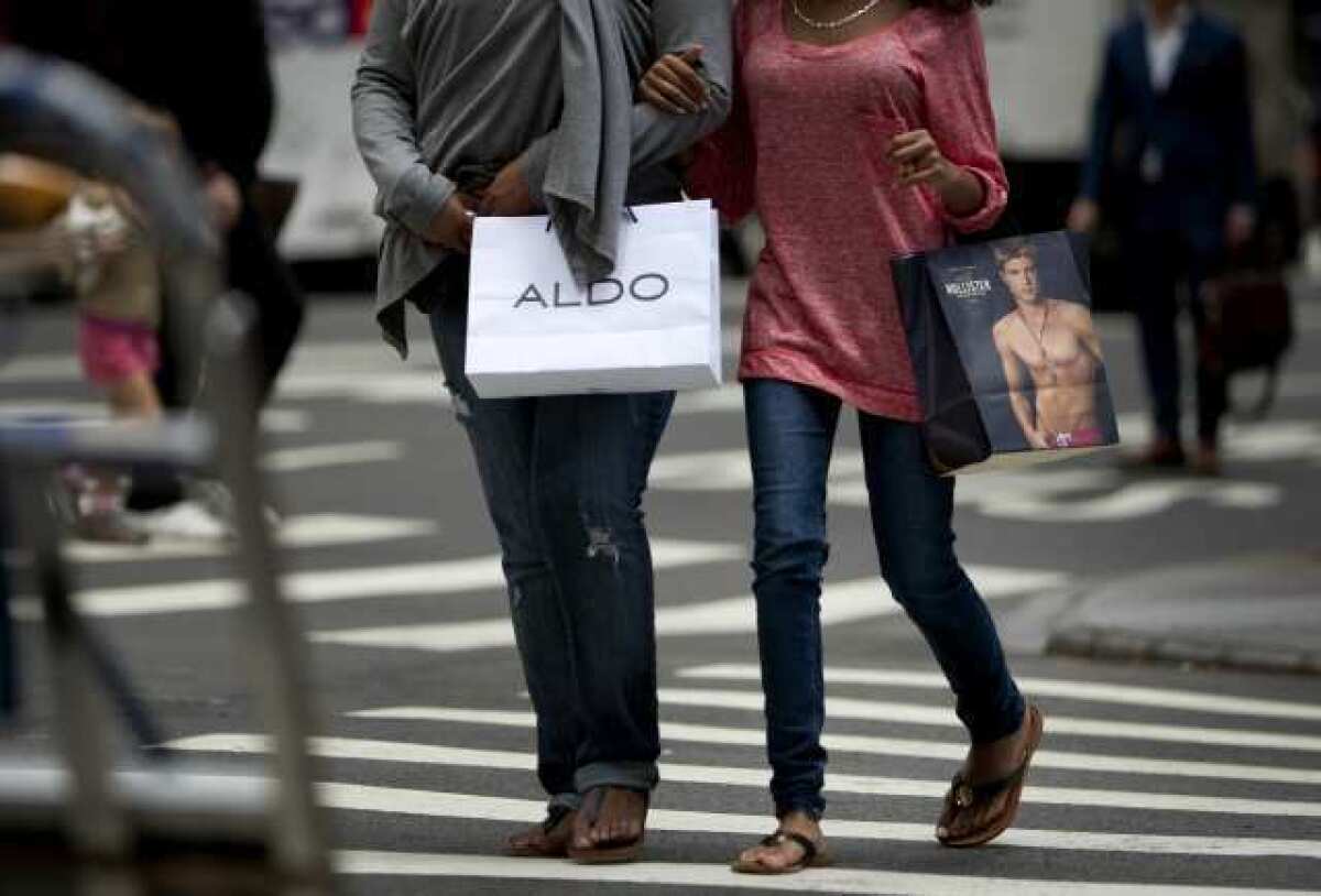 Shoppers walk down Madison Avenue in New York. Consumer confidence in July hit a fresh 2012 low amid sluggish hiring and slowing economic growth.