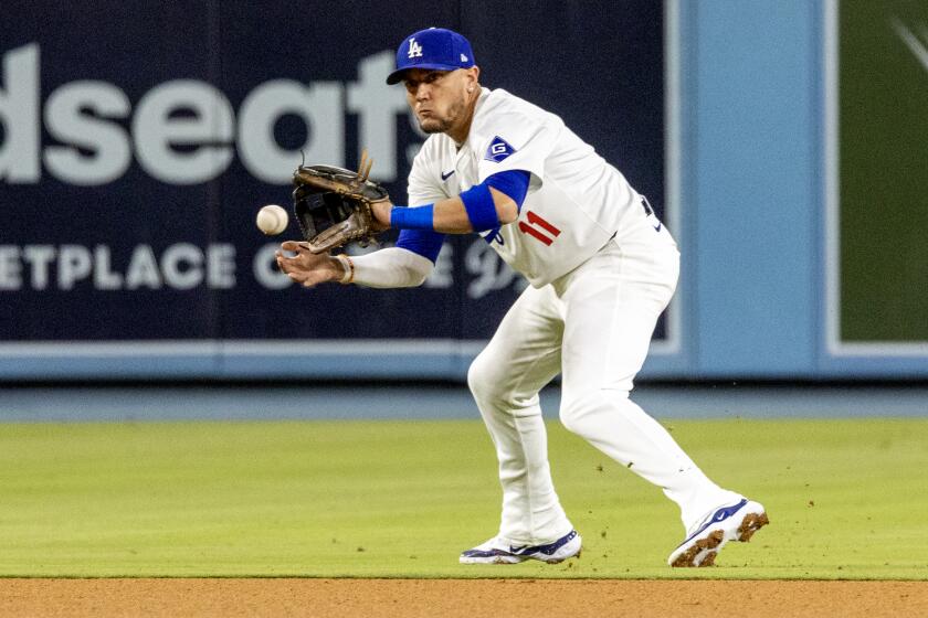 LOS ANGELES, CA - MAY 7, 2024: Los Angeles Dodgers shortstop Miguel Rojas (11) fields the ball and gets the runner out at second base on a fielders choice against the Miami Marlins in the seventh inning at Dodger Stadium on May 7, 2024 in Los Angeles, California.(Gina Ferazzi / Los Angeles Times)