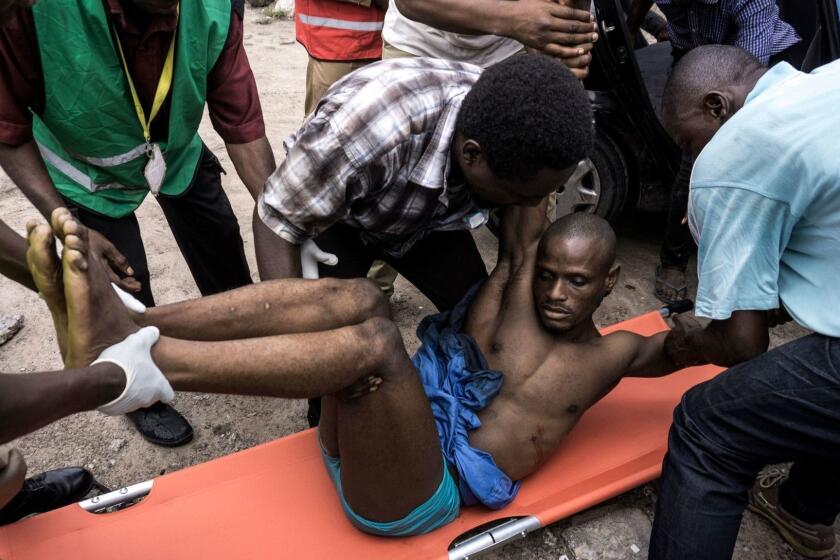 A Congolese man who moments later succumbed to his wound, is put on a stretcher after being shot during a protest called on by the Catholic Church, to push for the President of the Democratic Republic of the Congo, to step down on February 25, 2018 in Kinshasa. One person was killed and at least four injured as police fired live bullets and tear gas to disperse banned protests calling on DR Congo President Joseph Kabila to stand down. The church-backed protests in the Democratic Republic of Congo come after months of tension sparked by Kabila's prolonged rule and long-delayed elections in the vast and chronically unstable country. / AFP PHOTO / John WESSELSJOHN WESSELS/AFP/Getty Images ** OUTS - ELSENT, FPG, CM - OUTS * NM, PH, VA if sourced by CT, LA or MoD **