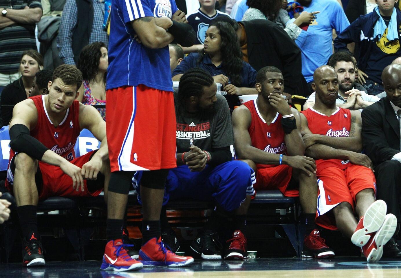 Clippers players (from left) Blake Griffin, Ronny Turiaf, Chris Paul and Chauncey Billups watch the closing minute of a 104-83 loss to the Grizzlies in Game 4 of their first-round playoff series Saturday afternoon at FedExForum in Memphis.