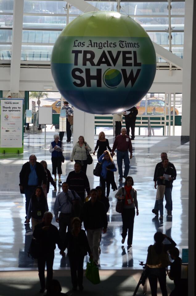 Early arrivals walk through the exhibit hall atrium on the way to the L.A. Times Travel Show.