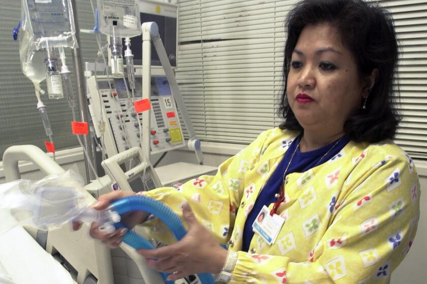 Lovely R. Suanino, a respiratory therapist at Newark Beth Israel Medical Center in Newark, N.J., demonstrates setting up a ventilator in the intensive care unit of the hospital. U.S. hospitals bracing for a possible onslaught of coronavirus patients with pneumonia and other breathing difficulties could face a critical shortage of mechanical ventilators and health care workers to operate them.