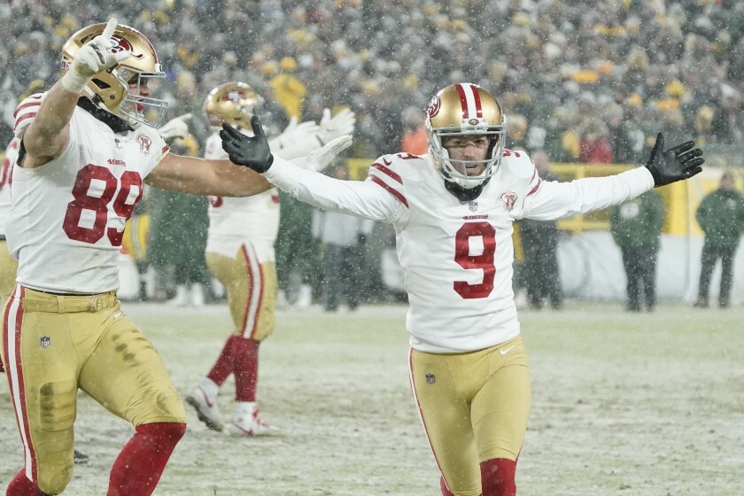 Robbie Gould of the 49ers celebrates his game-winning field goal on the road at snowy Lambeau Field.