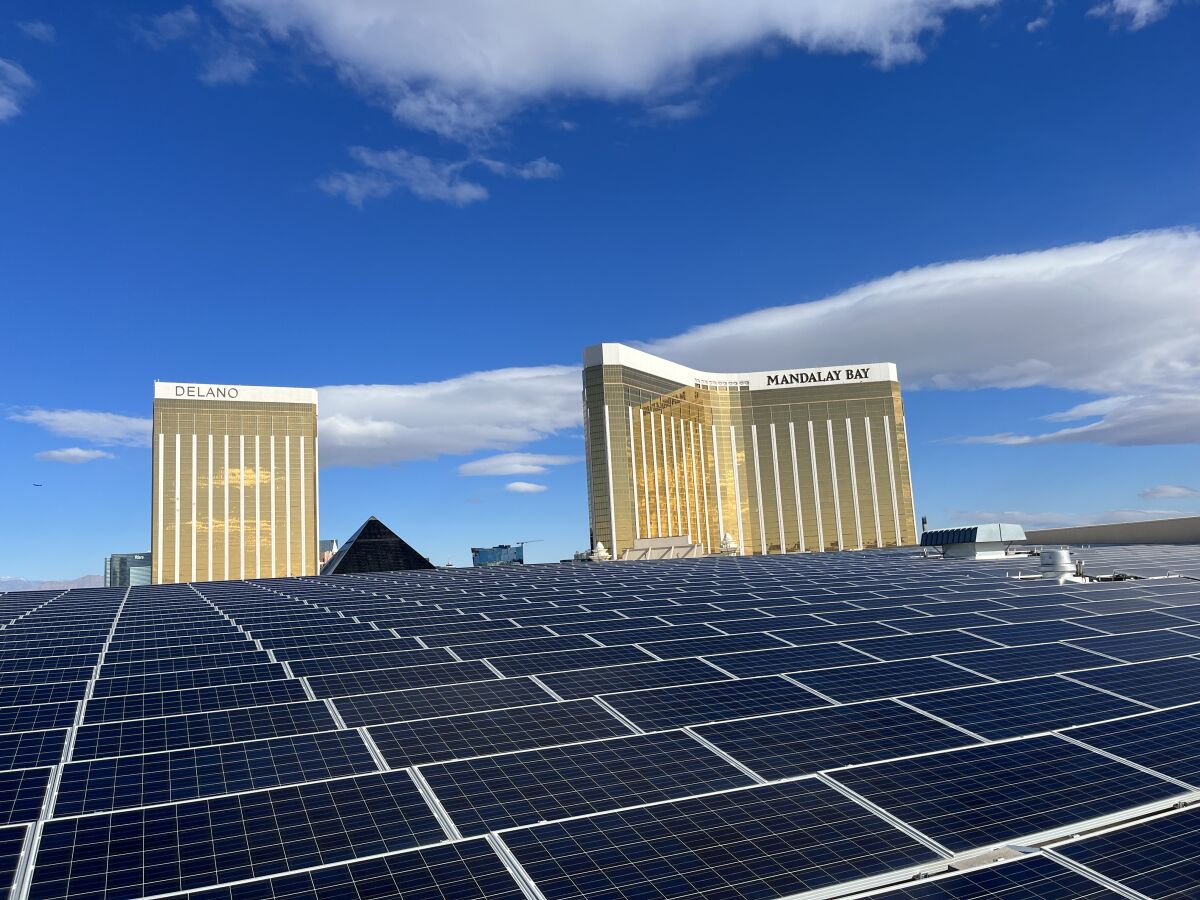 Two gold towers rise above solar panels.