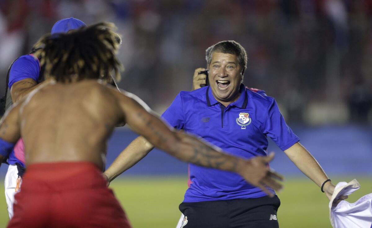 Panama's coach Hernan Dario Gomez, from Colombia, celebrates with his player Roman Torres who scored his team's second goal, after a 2018 Russia World Cup qualifying soccer match against Costa Rica in Panama City, Tuesday, Oct. 10, 2017.
