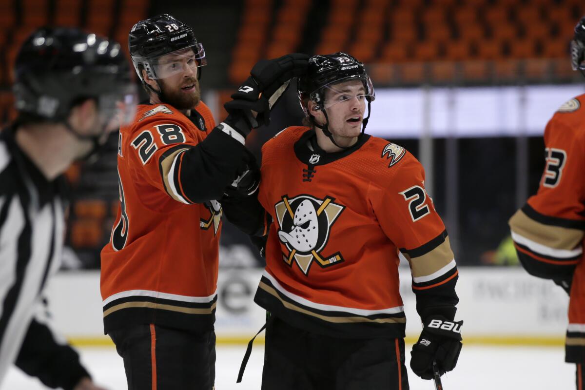 Anaheim Ducks defenseman Jani Hakanpaa celebrates a goal by center Sam Steel.