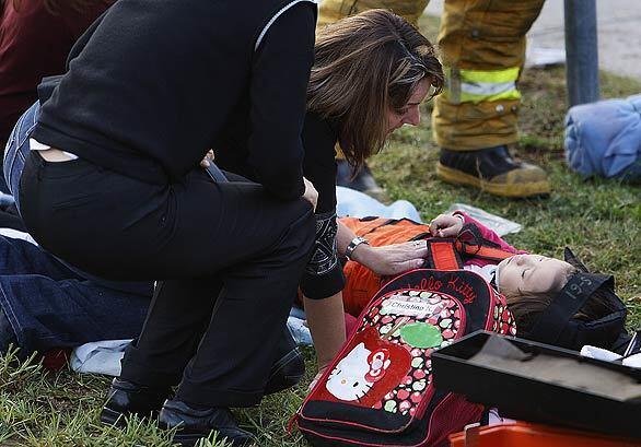 Lisa Esse comforts an injured girl who was struck by an SUV while walking to Maple Hill Elementary School in Diamond Bar.