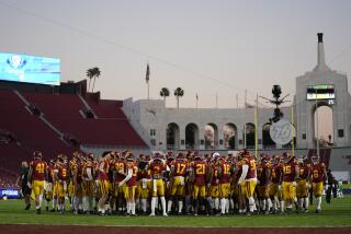 USC players gather on the field as they finish warming up before playing Oregon in the Pac-12 championship game 