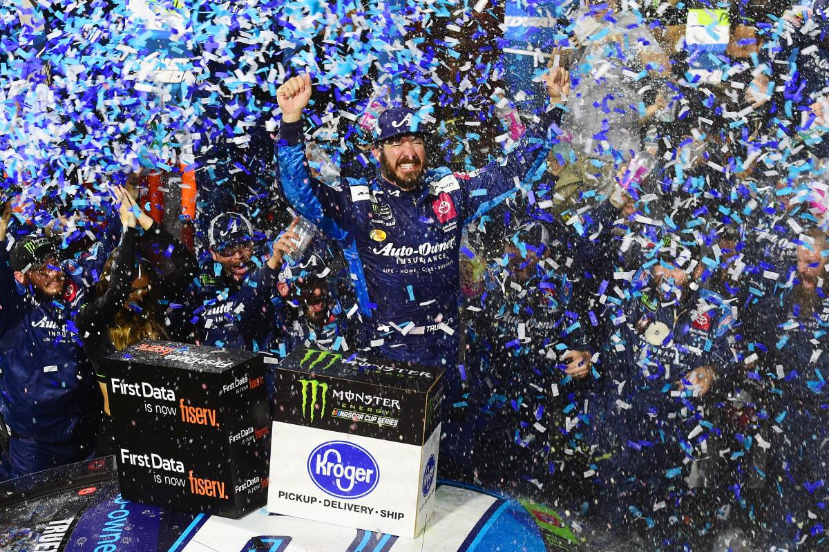 Martin Truex Jr. celebrates after winning a NASCAR Cup race at Martinsville Speedway on Sunday.