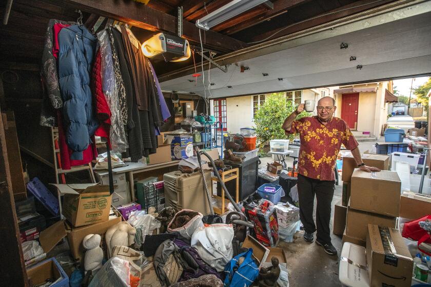 SAN MARINO, CA - DECEMBER 16: Andrew Kindler is photographed inside his garage at his home in San Marino next to packed boxes and items to be packed for an upcoming move to a new home in Northern Scottsdale, Arizona. Kindler and his wife Jo Anne are leaving California for a variety of reasons including higher taxes, anticipated future loss of property value, and declining quality of life. (Mel Melcon / Los Angeles Times)
