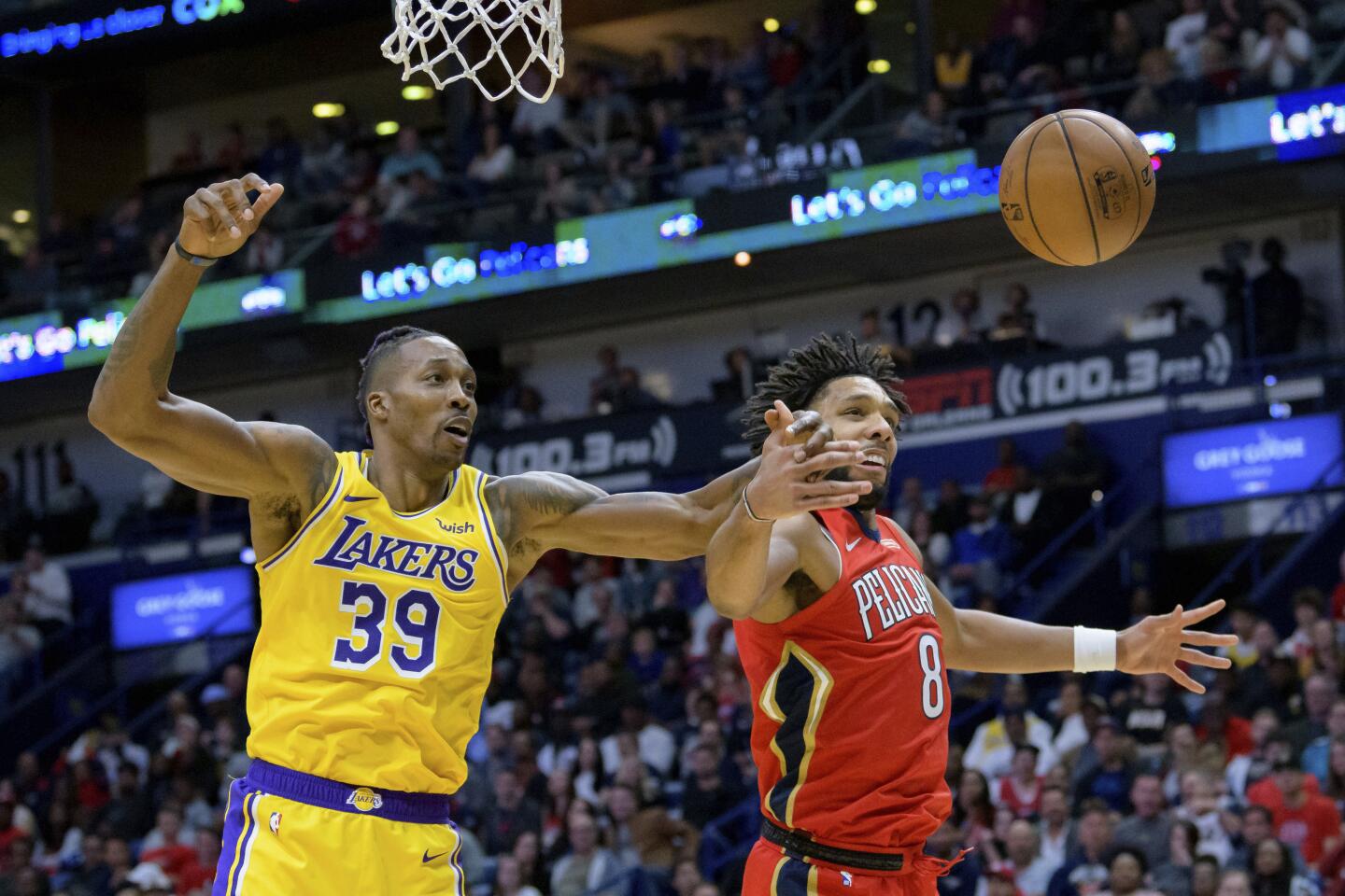 Pelicans center Jahlil Okafor (8) and Lakers center Dwight Howard (39) reach for a rebound during the second half of a game Nov. 27.