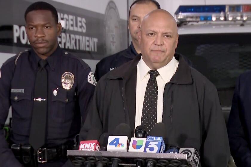 Det. Ryan Moreno of the LAPD South Traffic Division, center, speaks at press conference asking for help to ID victim 