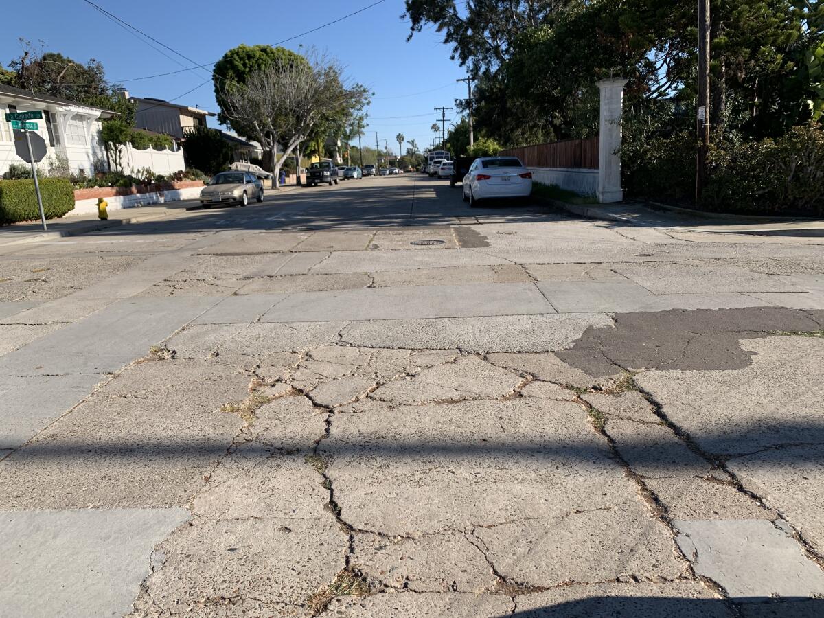 La Jolla's intersection of La Canada and La Jolla Hermosa Avenue shows cracks and asphalt patches.
