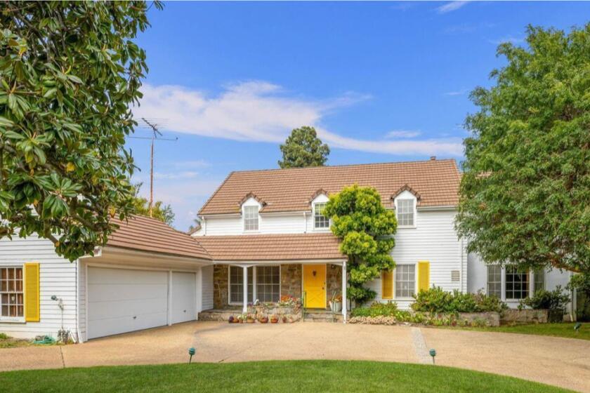 Built in the 1950s, the Colonial-style home sits on three-quarters of an acre and comes with a stone patio and swimming pool.