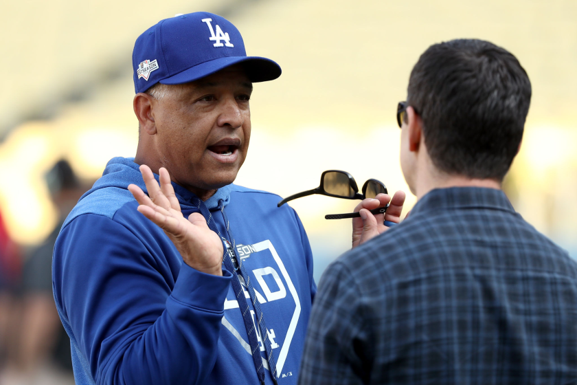 LOS ANGELES, CALIFORNIA - OCTOBER 09: Manager Dave Roberts of the Los Angeles Dodgers talks on the field.